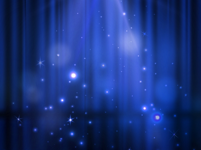 舞台の幕に光があたって輝いている画像