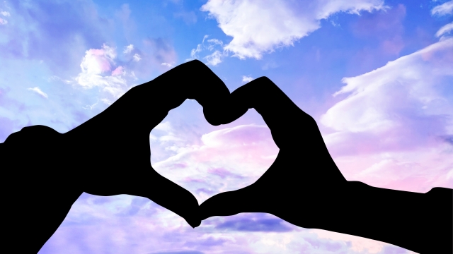 男女が手でハートを作っている画像